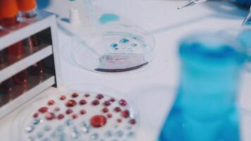 A laboratory table with a beaker and a glass video