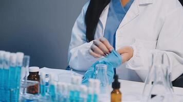 A woman in lab coat is working on a test tube video