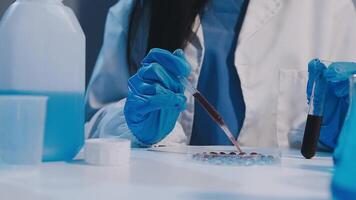 A person in a lab coat is holding a test tube video
