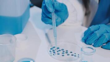 A person in a lab coat is holding a tube video