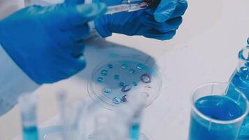 A person in a lab coat is holding a test tube video