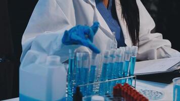 A woman in a lab coat is working on a computer video