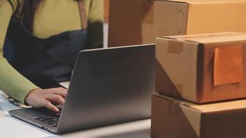 A woman working on her laptop in front of boxes video