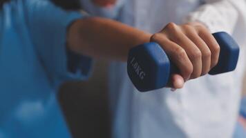 A person is holding a dumbbell in their hand video