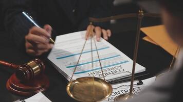 A lawyer signing a document with a scale video