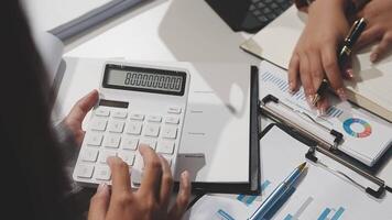A person is using a calculator to calculate the numbers video