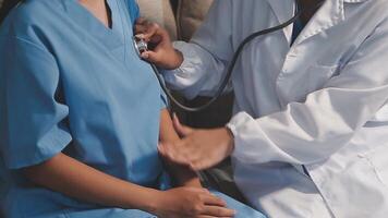 A doctor is examining a patient's chest with a stethoscope video