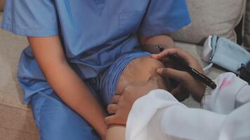 A doctor is examining a patient's knee video