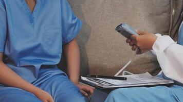 A nurse is using a cell phone to check the temperature of a patient video