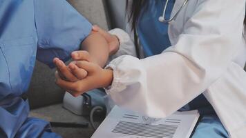 A doctor is holding the hand of a patient video