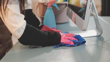 A person cleaning a desk with a computer video