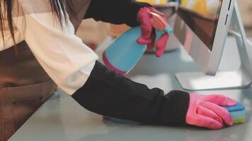 A person cleaning a computer with gloves video