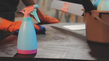 A person is using a spray bottle to clean a table video