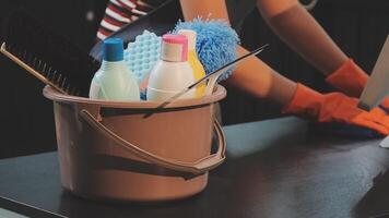 A woman is using a computer with a cleaning bucket video