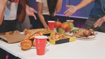People standing around a table with food and drinks video