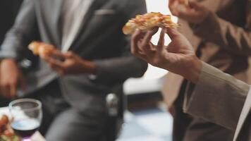 A group of people in business attire eating pizza video