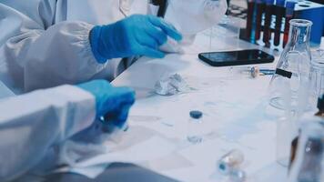 A person in a lab coat is working on something video