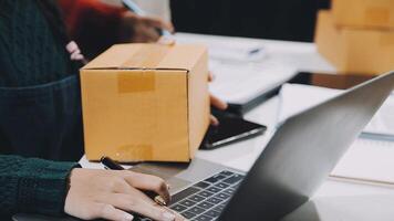 A person is using a laptop and a box video