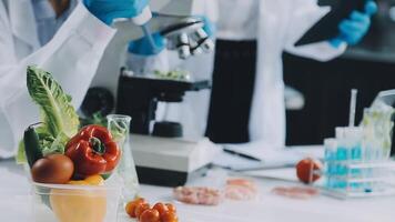 A scientist is using a microscope to look at vegetables video