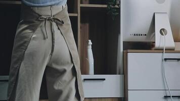 A woman is standing in front of a computer video