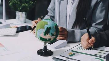 Business people working on a project with a globe video
