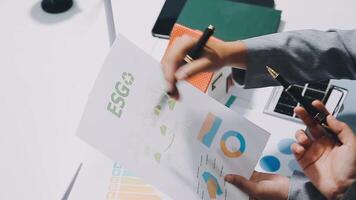 Business people working on a paper with graphs and graphs video
