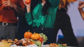 People are standing around a table with food video
