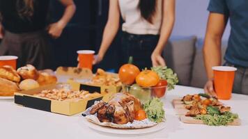 People standing around a table with food and drinks video