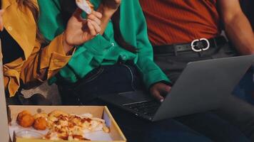 People eating pizza and drinking soda while sitting on a couch video