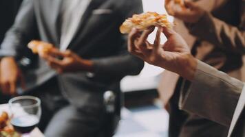 People in business attire eating pizza video