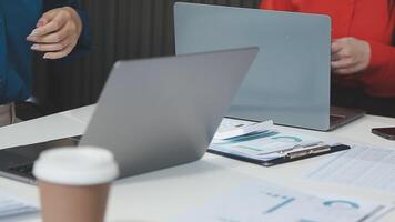 Two people working on laptops at a desk video