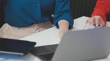 Two women are working on a laptop computer video
