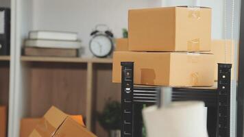 A stack of boxes in a room with a clock and other items video