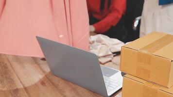 A laptop and boxes on a wooden table video