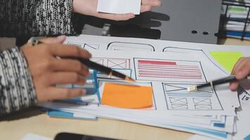 Two people working on a project with paper and pens video