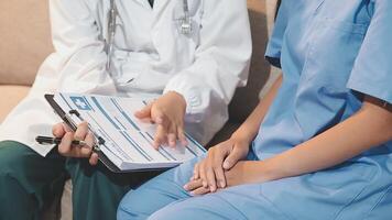 A doctor and patient sitting on a couch video