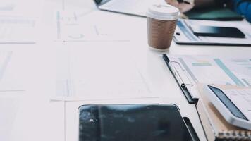 A table with a laptop, coffee cup and papers video