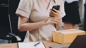 A woman in a business suit holding a cell phone video