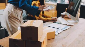 A woman is using a computer and a box is on the desk video