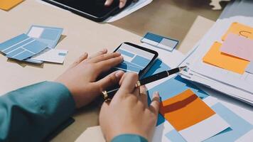 A person is using a cell phone while sitting at a desk video