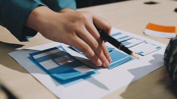 A person is working on a piece of paper with a pen video