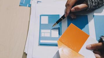 A person is using a pen to draw on paper video