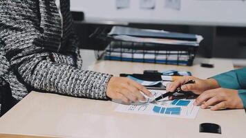 Two people sitting at a table with a pen and paper video