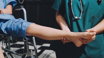 A doctor is holding the leg of a patient video