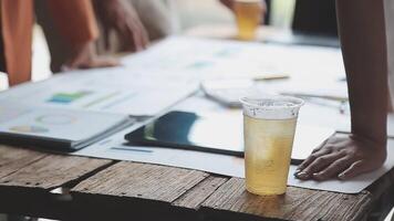 A person is holding a drink on a table video