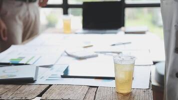 A glass of juice is on a table in a meeting room video