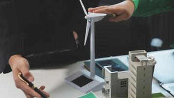 A man and woman are holding a wind turbine video