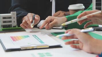 Business people working on a project with a graph on the table video