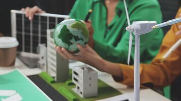 A group of people working on a project with wind turbines video