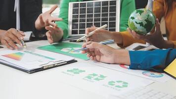 People working on a project with a green globe video